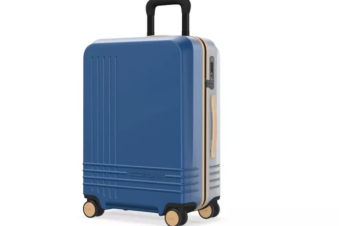 six carry-on suitcases lined up against an airport wall at night